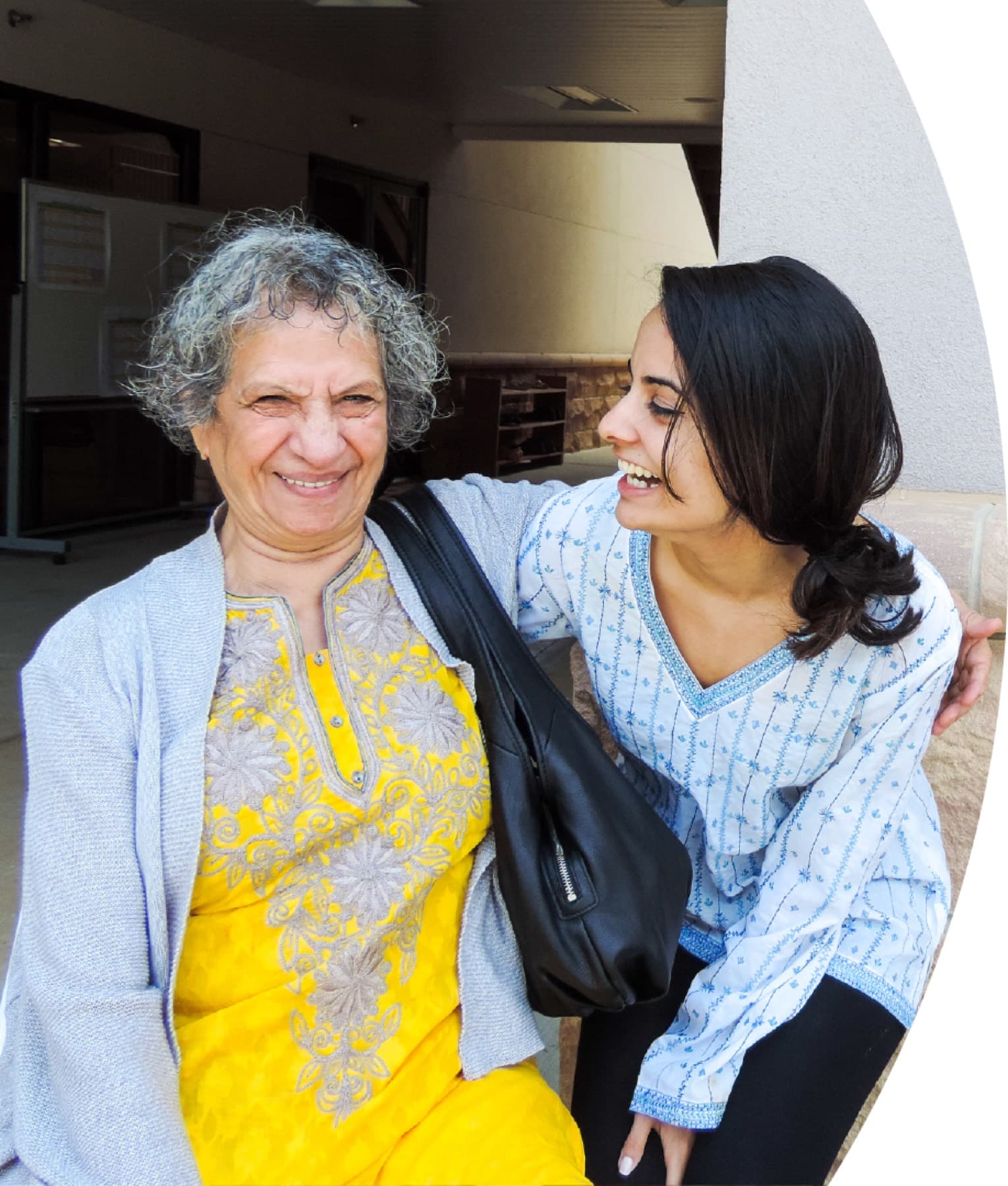 A Seva caregiver laughing with a senior client